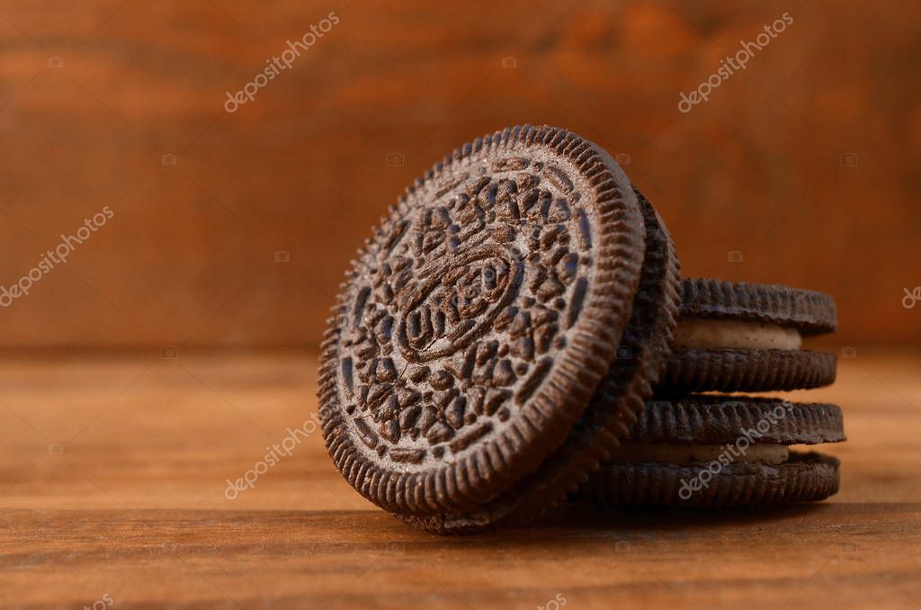 KHARKOV, UKRAINE - SEPTEMBER 8, 2019: Many OREO sandwich cream biscuits on wooden background. Oreo is a sandwich cookie with a sweet cream is the best selling cookie in the US