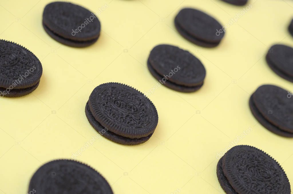 KHARKOV, UKRAINE - SEPTEMBER 8, 2019: Many OREO sandwich cream biscuits on yellow background. Oreo is a sandwich cookie with a sweet cream is the best selling cookie in the US
