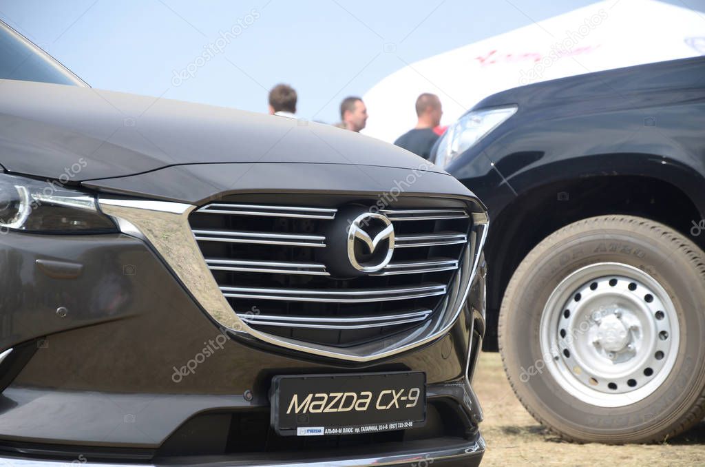 KHARKOV, UKRAINE - AUGUST 31, 2019: Mazda logo badge and car grill on Mazda CX-9 luxury vehicle. Mazda is Japanese automaker based in Fucha Aki District, Hiroshima Prefecture