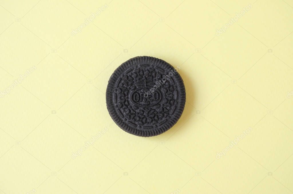 KHARKOV, UKRAINE - SEPTEMBER 8, 2019: One OREO sandwich cream biscuits on yellow background. Oreo is a sandwich cookie with a sweet cream is the best selling cookie in the US