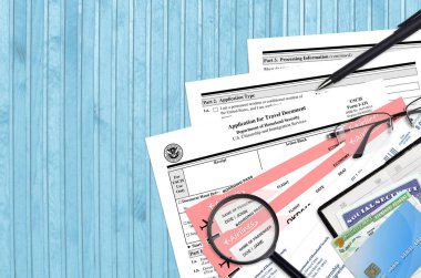 USCIS form I-131 seyahat belgesi için uygulama düz bir ofis masasında ve doldurmaya hazır. ABD Vatandaşlık ve Göçmenlik Bürosu evrakları konsepti. Üst görünüm