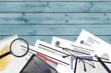 USCIS form I-140 göçmen işçiler için dilekçe düz bir ofis masasında ve doldurmaya hazır. ABD Vatandaşlık ve Göçmenlik Bürosu evrakları konsepti. Üst görünüm