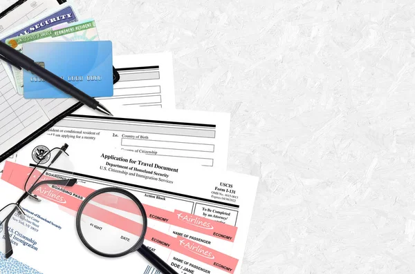 USCIS form I-131 Application for travel document lies on flat lay office table and ready to fill. U.S. Citizenship and Immigration services paperwork concept. Top view