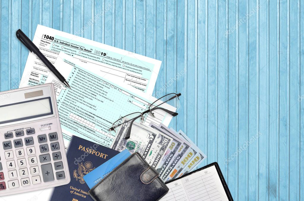 IRS form 1040 Individual income tax return lies on flat lay office table and ready to fill. U.S. Internal revenue services paperwork concept. Time to pay taxes in United States. Top view