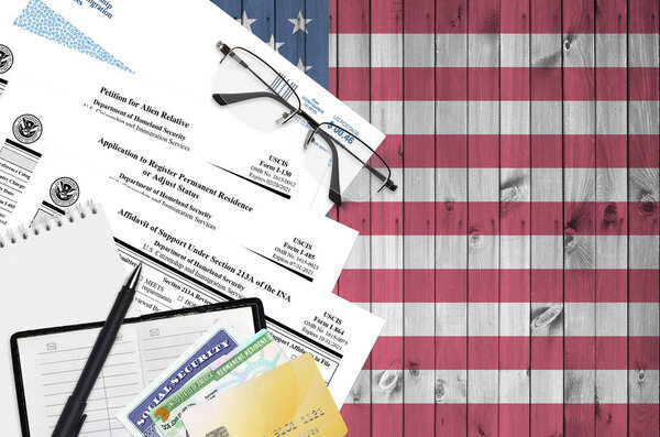 I-130 Petition for alien relative, I-485 Application to register permanent residence or adjust status and I-864 Affidavit of support under section 213A of the INA forms lies on table and ready to fill