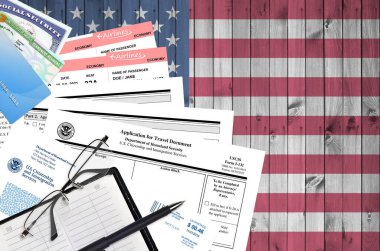 USCIS form I-131 Application for travel document lies on flat lay office table and ready to fill. U.S. Citizenship and Immigration services paperwork concept. Top view clipart