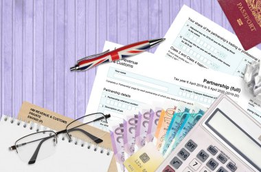 English Tax form sa104 Partnership from HM revenue and customs lies on table with office items. HMRC paperwork and tax paying process in United Kingdom of Great Britain clipart