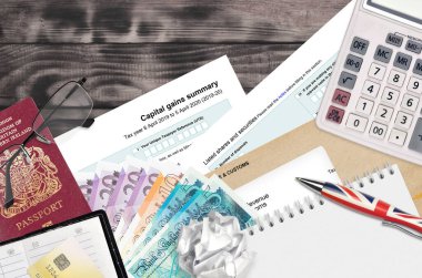 İngiliz Vergi formu sa107 Capital kazanç özeti HM gelir ve gümrük ofis eşyalarıyla birlikte masadadır. İngiltere Birleşik Krallığında HMRC evrakları ve vergi ödeme süreci