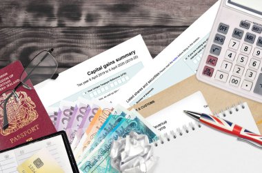 English Tax form sa107 Capital gains summary from HM revenue and customs lies on table with office items. HMRC paperwork and tax paying process in United Kingdom of Great Britain clipart