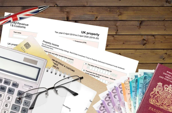 English Tax form sa105 UK Property from HM revenue and customs lies on table with office items. HMRC paperwork and tax paying process in United Kingdom of Great Britain