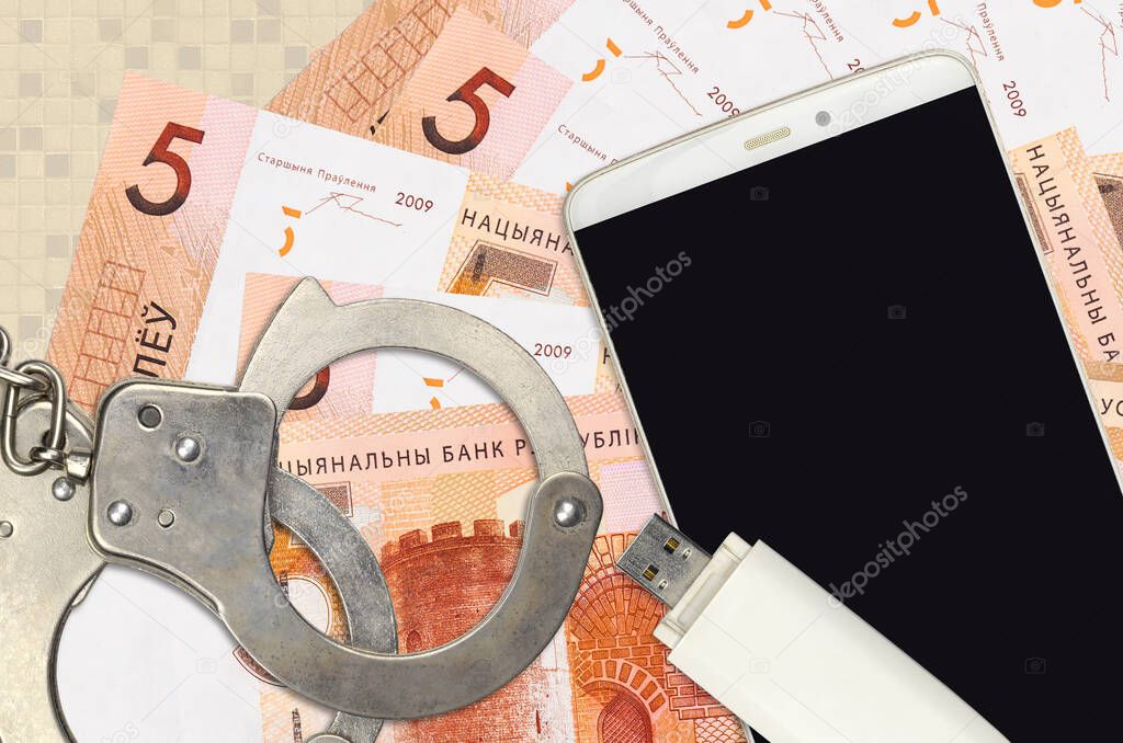 5 Belorussian rubles bills and smartphone with police handcuffs. Concept of hackers phishing attacks, illegal scam or online spyware soft distribution
