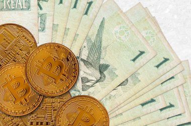 1 Brezilyalı gerçek banknot ve altın bitcoin. Kripto para birimi yatırım konsepti. Kripto madenciliği veya ticari işlemler