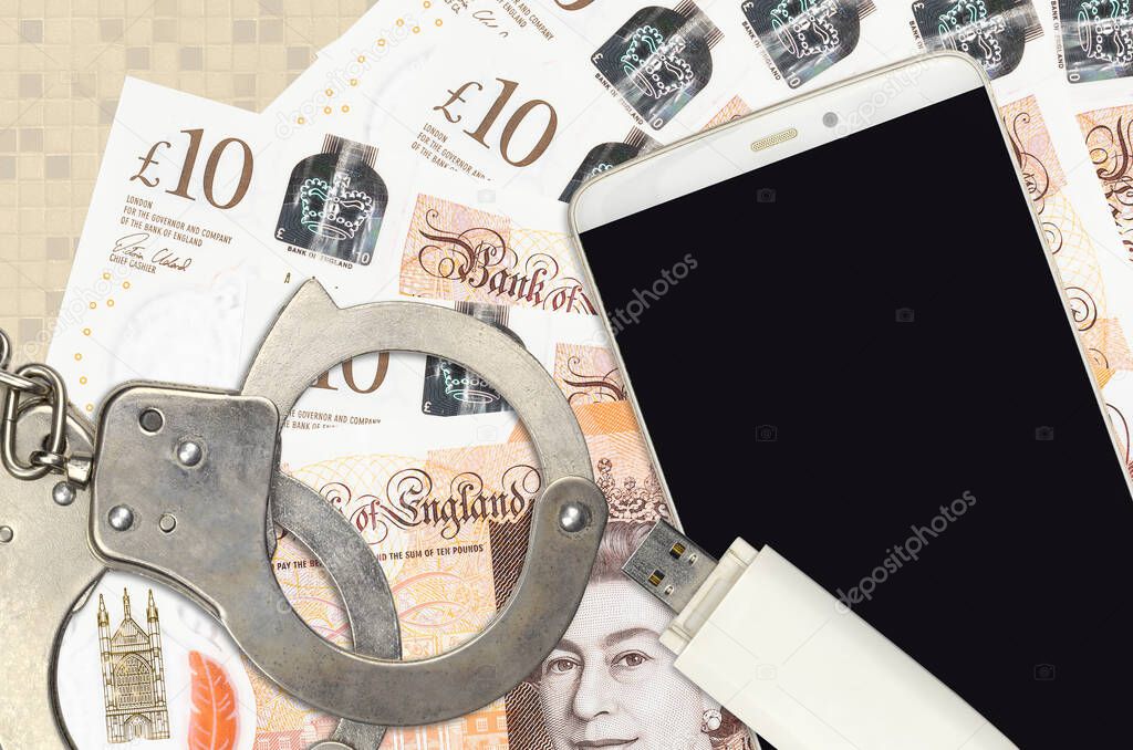 10 British pounds bills and smartphone with police handcuffs. Concept of hackers phishing attacks, illegal scam or online spyware soft distribution