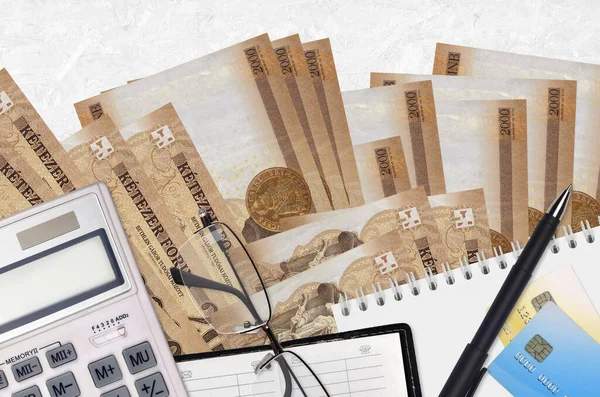 2000ハンガリーの紙幣と眼鏡とペンで計算機 納税の季節の概念または投資ソリューション 財務計画又は会計事務 — ストック写真