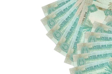 10 BAE dirhem banknotları beyaz arka planda fotokopi alanı ile izole edilmiş yatar. Zengin yaşam kavramsal geçmişi. Büyük miktarda ulusal para birimi zenginliği
