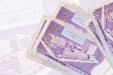 100 Filipin piso faturası büyük yarı şeffaf banknotun arka planında duruyor. Ulusal para biriminin soyut sunumu. İş konsepti