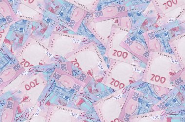 200 Ukrayna hrivniası banknotları büyük yığının içinde yatıyor. Zengin yaşam kavramsal geçmişi. Büyük miktarda para.
