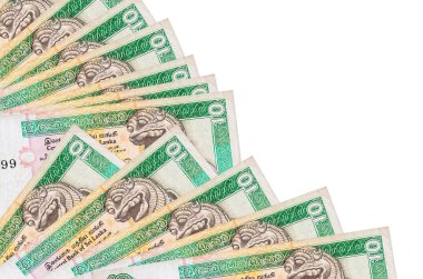 10 Sri Lanka Rupisi banknotları beyaz arka planda izole edilmiş bir şekilde duruyor ve fotokopi alanı da vantilatöre yakın duruyor. Maaş zamanı kavramı veya finansal işlemler