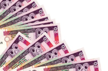 20 Sri Lanka rupi banknotları beyaz arka planda izole edilmiş, fotokopi alanı da yakın planda. Maaş zamanı kavramı veya finansal işlemler