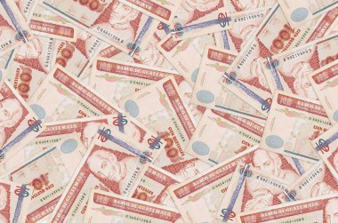 100 Guatemalan quetzales bills lies in big pile. Rich life conceptual background. Big amount of money clipart
