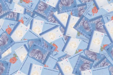 1 Malezya ringgit banknotları büyük yığının içinde yatıyor. Zengin yaşam kavramsal geçmişi. Büyük miktarda para.