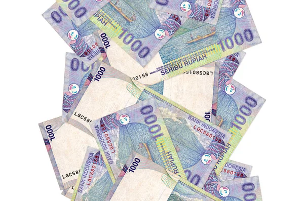 1000インドネシアルピア紙幣が白で孤立して飛んでいます 左右に白書スペースのある紙幣が多い — ストック写真