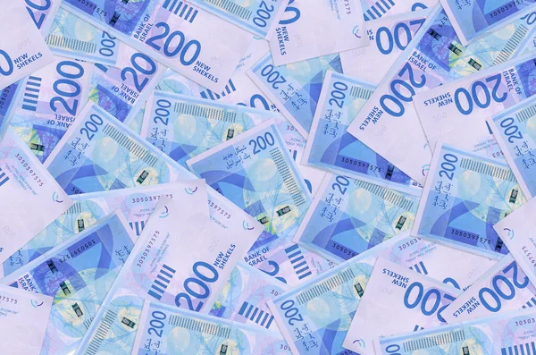 200 Israeli new shekels bills lies in big pile. Rich life conceptual background. Big amount of money