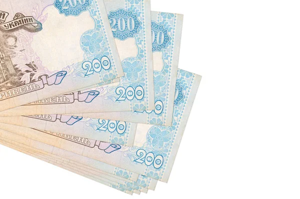 200 Ukrayna hrivniası banknotları küçük gruplar halinde ya da beyazın üzerine izole edilmiş paketler halinde yatar. Kopyalama alanı olan bir model. İş ve para değişimi kavramı