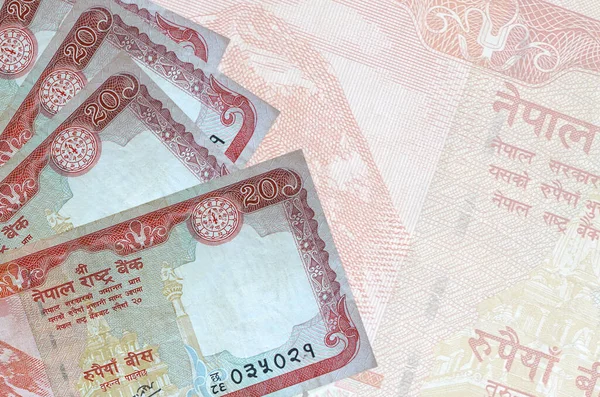 20のネパールのルピー札は 大きな半透明の銀行券を背景に積み重なっています コピースペース付き概要事業の背景 — ストック写真