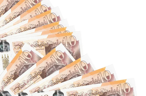 10 İngiliz sterlinli banknotlar beyaz arka planda izole edilmiş, fotokopi alanı da pervaneye yakın duruyor. Maaş zamanı kavramı veya finansal işlemler