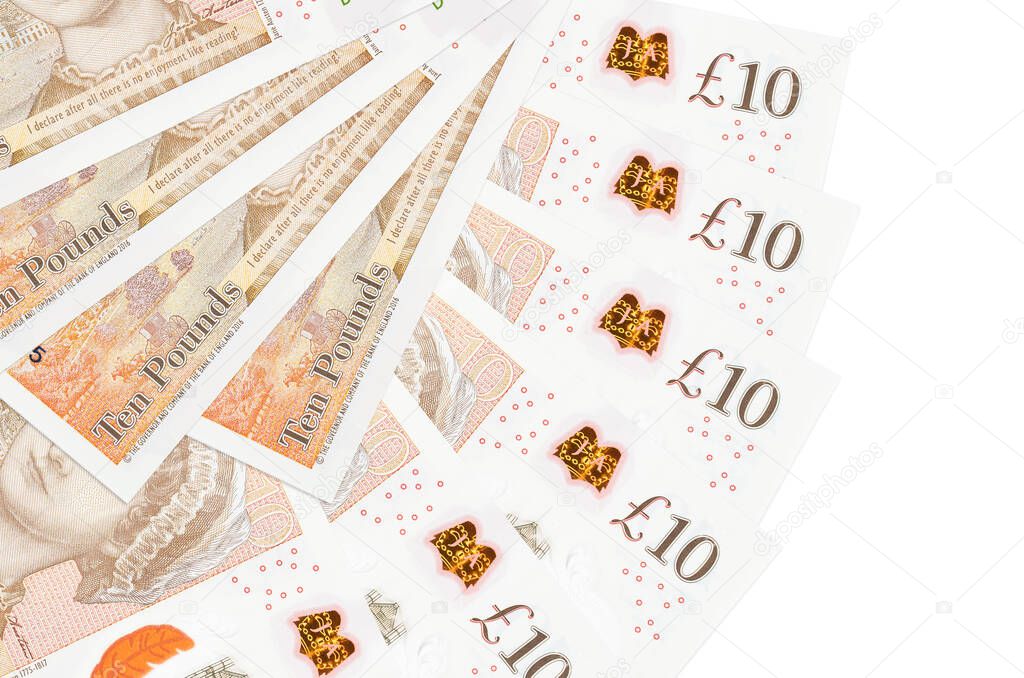 10 British pounds bills lies isolated on white background with copy space stacked in fan shape close up. Financial transactions concept