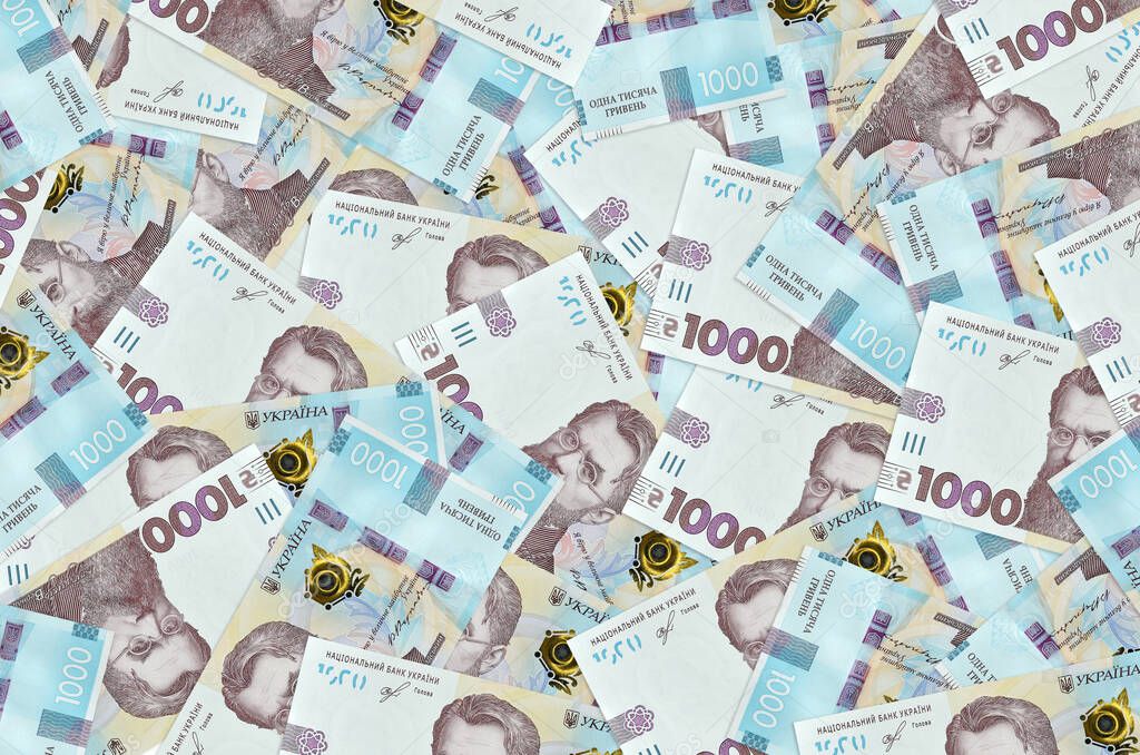 1000 Ukrainian hryvnias bills lies in big pile. Rich life conceptual background. Big amount of money