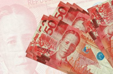 50 Filipin piso faturası büyük yarı şeffaf banknotun arka planında duruyor. Ulusal para biriminin soyut sunumu. İş konsepti