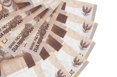 2000 Endonezya rupiası banknotları beyaz arka planda izole edilmiş bir şekilde duruyor ve fotokopi alanı da hayran şeklinde. Finansal işlemler kavramı