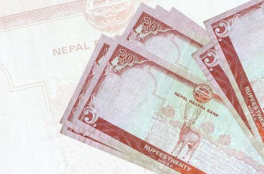 20 Nepal Rupisi banknotları büyük yarı şeffaf banknotların arka planında duruyor. Ulusal para biriminin soyut sunumu. İş konsepti