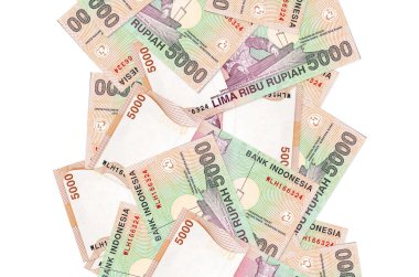 5000 Endonezya rupia banknotu beyazın üzerinde izole bir şekilde uçuyor. Birçok banknot sol ve sağ tarafta beyaz kopya alanı ile düşüyor