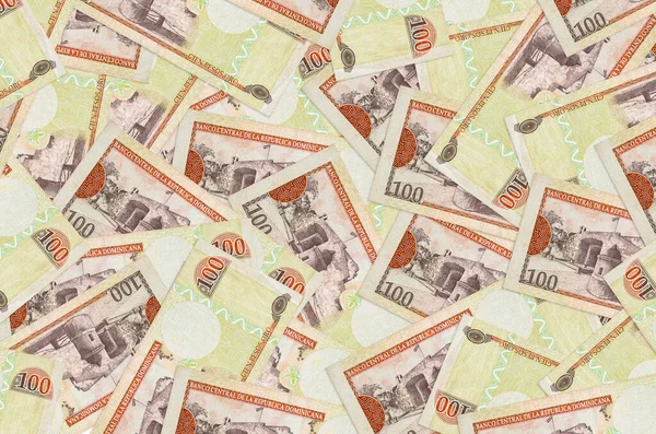 100 Dominik pezosu büyük bir yığın halinde duruyor. Zengin yaşam kavramsal geçmişi. Büyük miktarda para.