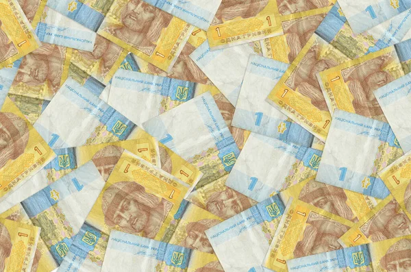 1 Ukrayna Hryvnia senedi büyük bir yığın halinde duruyor. Zengin yaşam kavramsal geçmişi. Büyük miktarda para.