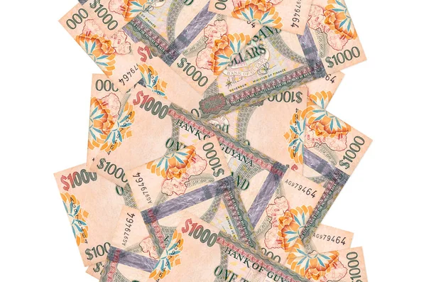 Beyaz üzerinde izole edilmiş 1000 Guyanese doları uçuyor. Birçok banknot sol ve sağ tarafta beyaz kopya alanı ile düşüyor