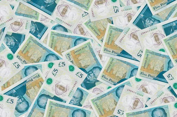 5 İngiliz sterlinli banknotlar yığınla var. Zengin yaşam kavramsal geçmişi. Büyük miktarda para.