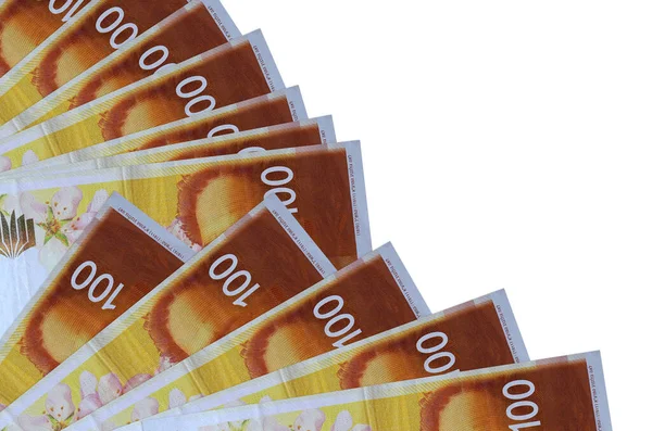 100 Israeli new shekels bills lies isolated on white background with copy space stacked in fan close up. Payday time concept or financial operations