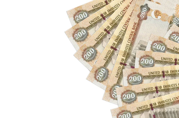 200 BAE dirhem banknotu, kopyalama alanı olan beyaz arkaplanda izole bir şekilde yatıyor. Zengin yaşam kavramsal geçmişi. Büyük miktarda ulusal para birimi zenginliği