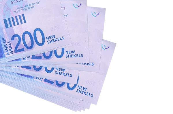 200 Israeli new shekels bills lies in small bunch or pack isolated on white. Mockup with copy space. Business and currency exchange concept