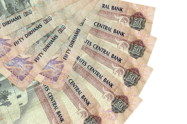 50 BAE dirhem banknotları beyaz arka planda izole edilmiş, fotokopi alanı da yakın planda. Finansal işlemler kavramı