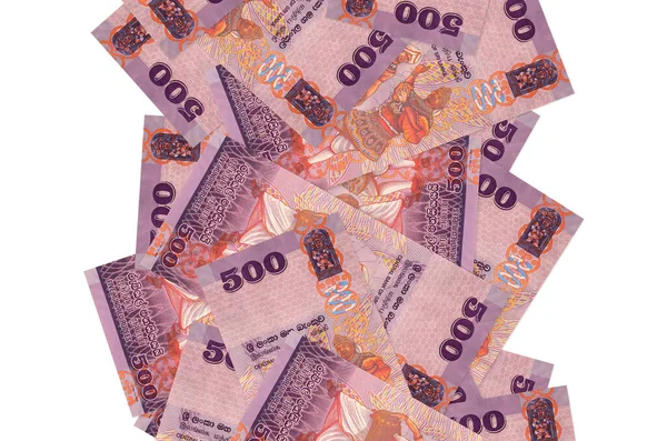 500 Sri Lanka rupisi beyazlar üzerinde izole bir şekilde uçuyor. Birçok banknot sol ve sağ tarafta beyaz kopya alanı ile düşüyor