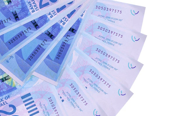 200 Israeli new shekels bills lies isolated on white background with copy space stacked in fan shape close up. Financial transactions concept