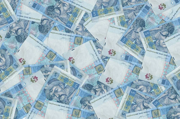 5 Ukrainian hryvnias bills lies in big pile. Rich life conceptual background. Big amount of money