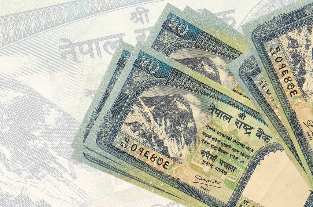 50 Nepalese Rupees Bills Lies In Stack On Background Of Big Semi Transparent Banknote Abstract Presentation Of National Currency Business Concept Larastock