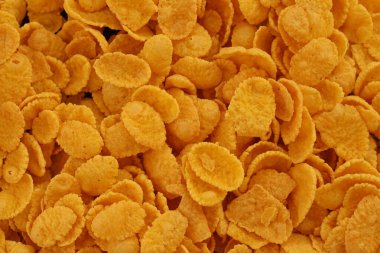 Mısır gevreği arkaplanı ve dokuyu kapatır. Sabah kahvaltısı için mısır gevreği.