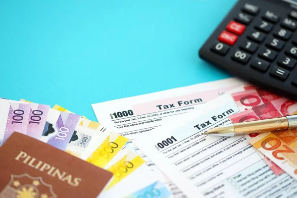 Filipinler pezosu para faturaları ve mavi üzerine yakın vergi formlu hesap makinesi. Vergi ve muhasebe kavramı